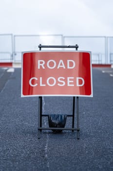 A Road Closed Sign In An Empty Urban Street