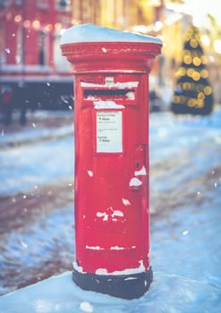 Traditional Red British Royal Mail Post Box In A Snowy Village At Christmas