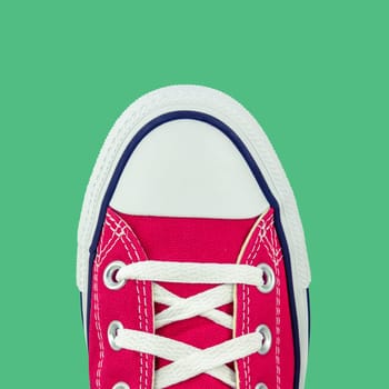 Retro Vintage Red Canvas Basketball Boots From Above On A Green Background