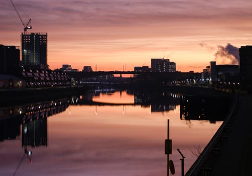 The Glasgow Skyline Reflected In The River Clyde During A Beautiful Sunrise