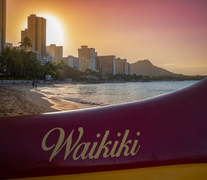 A Traditional Hawaiian Outrigger Canoe On Waikiki Beach At Sunset