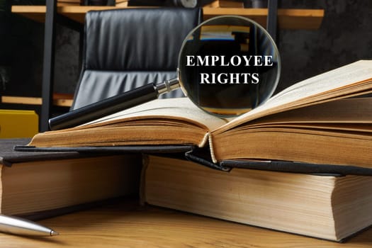 Employee rights concept. Open book and magnifying glass.