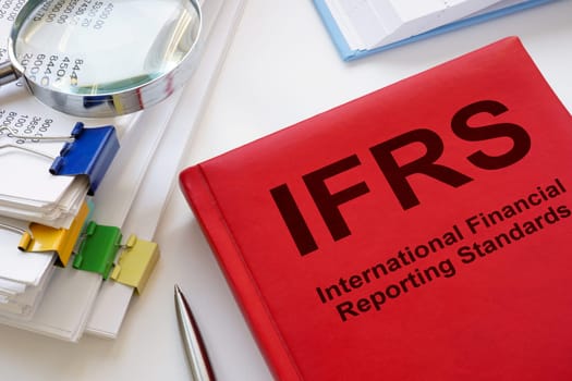 A stack of papers and book IFRS International Financial Reporting Standards.