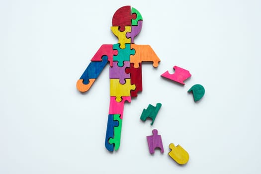 Figurine made from multi-colored puzzles. Psychotherapy and Self-acceptance.