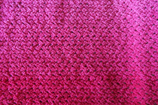 Close-Up of an Intricately Textured Pink Crocheted Blanket