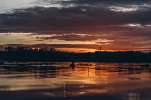Silhouettes of birds on peaceful water of sunset lake, Bagry lagoon in Poland