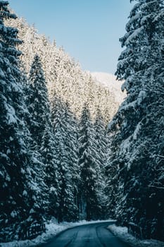 Snowy and frozen mountain road in winter, rural landscape of Low Tatras, Slovakia