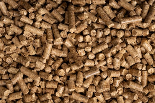 Wood pellet background. Close up natural wood pellet. Ecological heating, renewable energies Biofuels. Top view. Flat ecological fuel for solid fuel boilers.