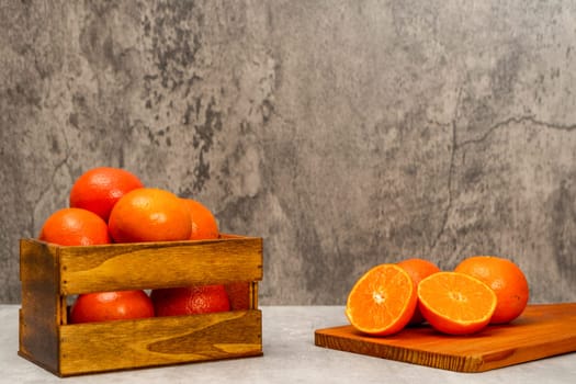 Fresh oranges in a wooden basket. Home gardening. Mandarin oranges. Mandarin oranges. Orange.