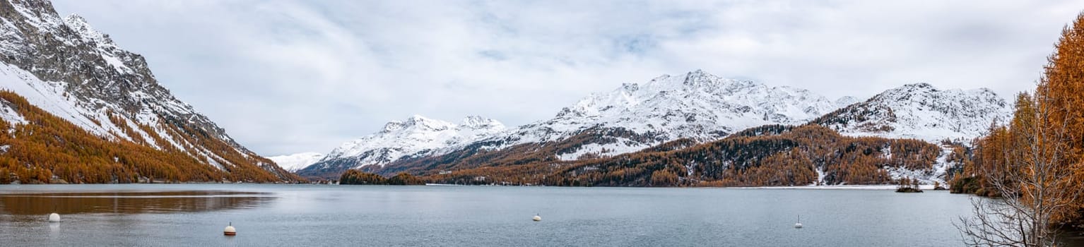 Lake Silsersee in autumn with snowcapped mountains, near St. Moritz, Switzerland