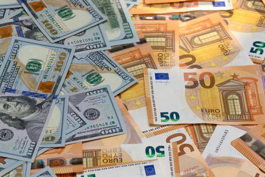 50 euro and 100 dollar bills scattered on the table as a background 21