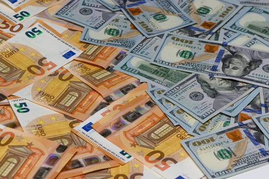50 euro and 100 dollar bills scattered on the table as a background 23