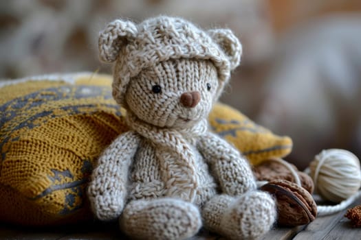 A handmade knitted teddy bear and knitting needles. The concept of manual labor. AI generated..
