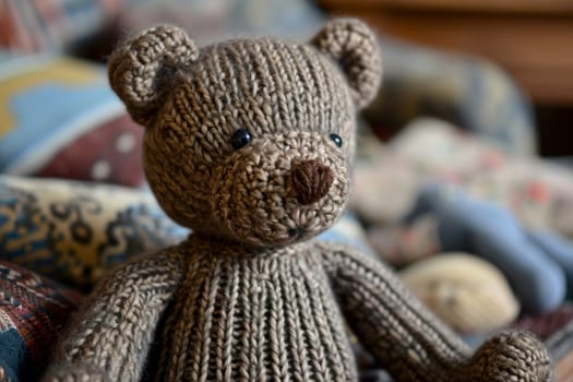 A handmade knitted teddy bear and knitting needles. The concept of manual labor. AI generated..