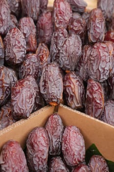 many date fruits display for sale at local market .