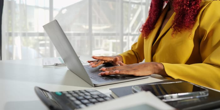 African close up of a businesswoman hand working on laptop.