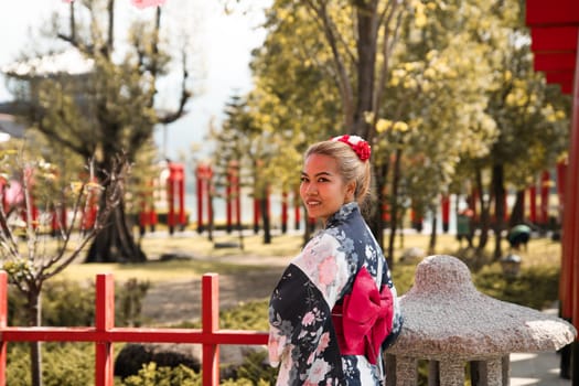 Asian girl in kimono and umbrella in Japanese theme park Hinoki Land in Chai Prakan District, Chiang Mai