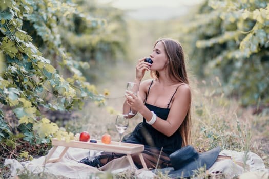 Picnic and wine tasting at sunset in the hills of Italy, Tuscany. Vineyards and open nature in the summer. Romantic dinner, fruit and wine.