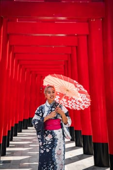 Asian girl in kimono and umbrella in Japanese theme park Hinoki Land in Chai Prakan District, Chiang Mai