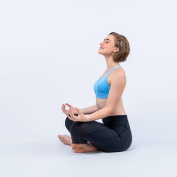 Full body length gaiety shot athletic and sporty woman doing healthy and meditative yoga exercise workout posture on isolated background. Healthy active and body care lifestyle