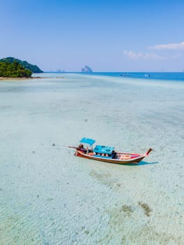 longtail boat in the turqouse colored ocean with clear water at Koh Kradan a tropical island in Trang Thailand