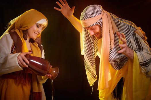 A couple in love or a married couple in stylized Eastern clothing from Israel, Palestine, Iran, Pakistan together. Tender photo session in the style of the Middle East and the Bible