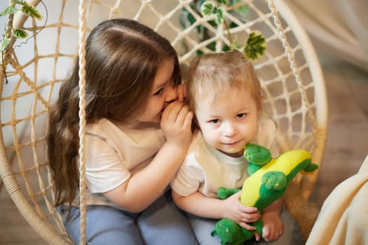 Happy time concept. Girls Sisters in chair and having fun. Female Preschooler and teenager playing and relaxing in room