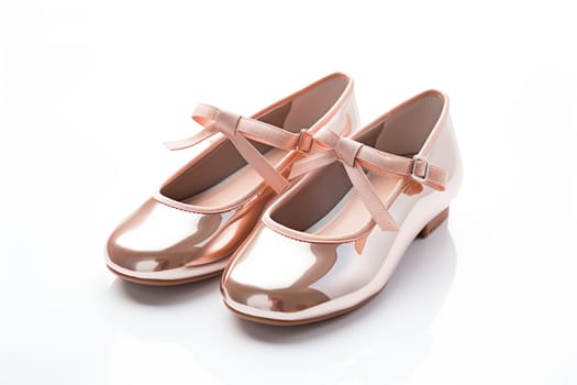 Cute pink shoes with a bow for little girls on a white background.