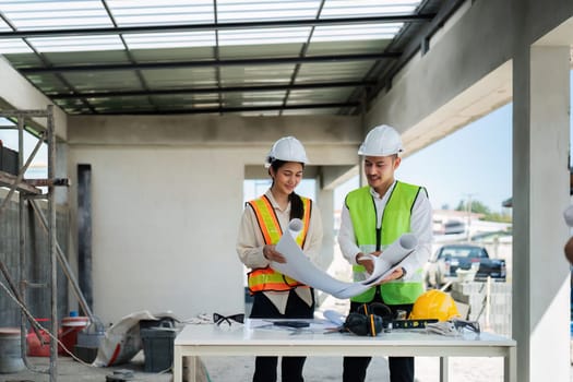 team engineer, foreman, architect meeting for colleagues discussing and checks construction blueprints at onsite.