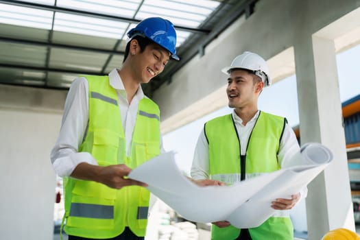 team engineer, foreman, architect meeting for colleagues discussing and checks construction blueprints at onsite.