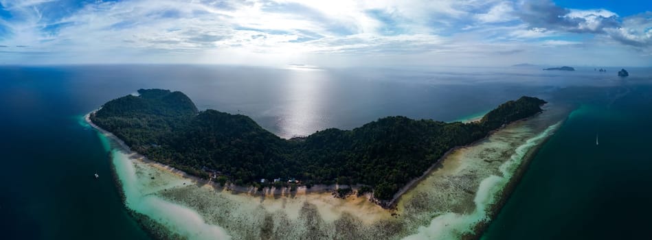 panoramic view Drone aerial view at Koh Kradan a tropical island with palm trees soft white sand, and a turqouse colored ocean in Koh Kradan Trang Thailand