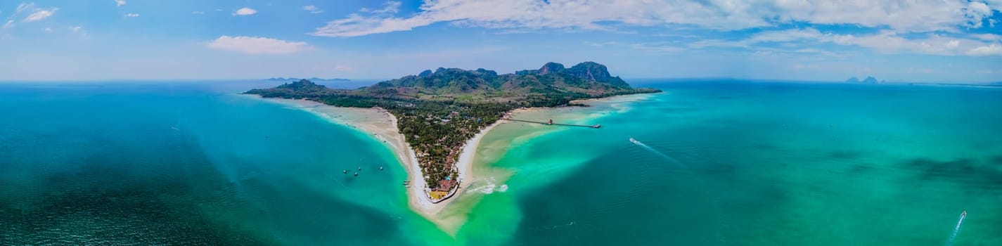 Drone aerial view from above at Koh Muk a tropical island with palm trees and soft white sand, and a turqouse colored ocean in Koh Mook Trang Thailand