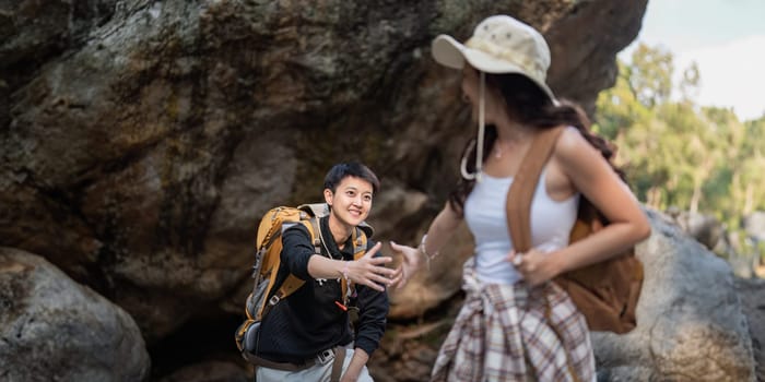 Lovely couple lesbian woman with backpack hiking in nature. Loving LGBT romantic moment in mountains.