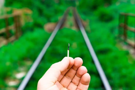 Matches on a rails railroad tracks background, fire on railways concept