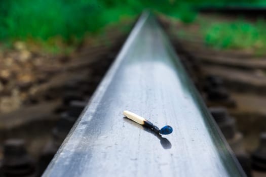 Matches on a rails railroad tracks background, fire on railways concept