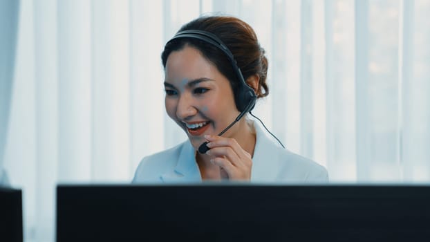 Businesswoman wearing vivancy headset working in office to support remote customer or colleague. Call center, telemarketing, customer support agent provide service on telephone video conference call