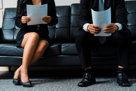 Stressed businessman and businesswoman candidate sit and wait for interview at the company office. Job application, business recruitment and Asian labor hiring concept. uds