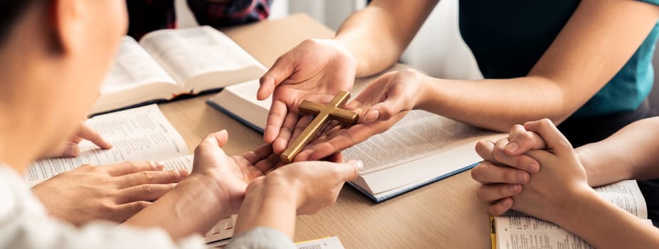 Close-up women prayer deliver holy bible book and holy cross to believer group. Spreading religion symbol. Concept of hope, religion, christianity and god blessing. Warm background. Burgeoning.