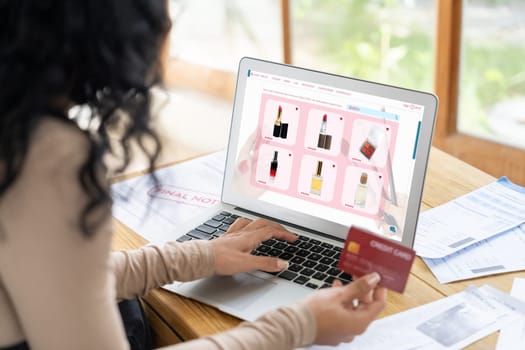 Woman shopping online on internet marketplace browsing for sale items for modern lifestyle and use credit card for online payment from wallet protected by crucial cyber security software