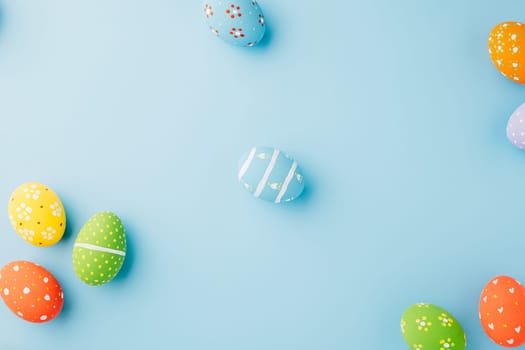 Overhead easter eggs isolated on blue background with copy space, Funny decoration, Happy Easter Day greeting card, Creative composition banner web design holiday background, flat lay top view