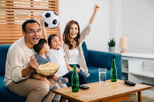 With enthusiasm, a family and their daughter enjoy watching football on TV at home, creating an atmosphere of togetherness and bonding. Their cheers and laughter reflect the joy of the game.
