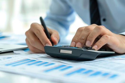 Financial data analyzing counting concept for Businessman's hands with calculator and laptop on desk in modern office. Generative AI.