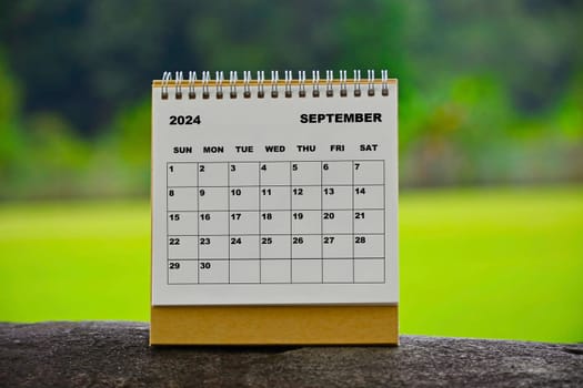 September 2024 white calendar with green blurred background - New year concept.