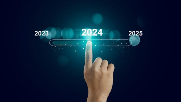 Human hand touch on virtual bar status to change from 2023 to 2024 and 2025 for preparation and focus new business concept, establish goals and a business plan, start new business and new life