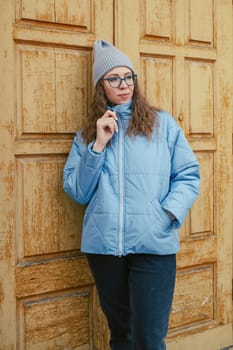 Portrait of a stylish woman in blue jacket. Spring outdoor portrait.