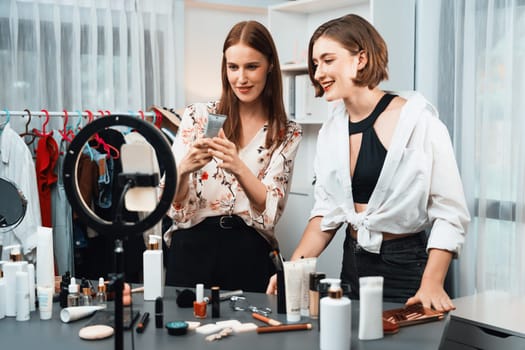 Woman influencer shoot live streaming vlog video review makeup utmost social media or blog. Happy young girl with cosmetics studio lighting for marketing recording session broadcasting online.