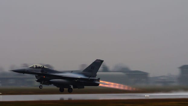 US combat aircraft takes off, its afterburner flame stark against the backdrop, ready to safeguard NATO airspace from any threat including terrorist. Copy Space