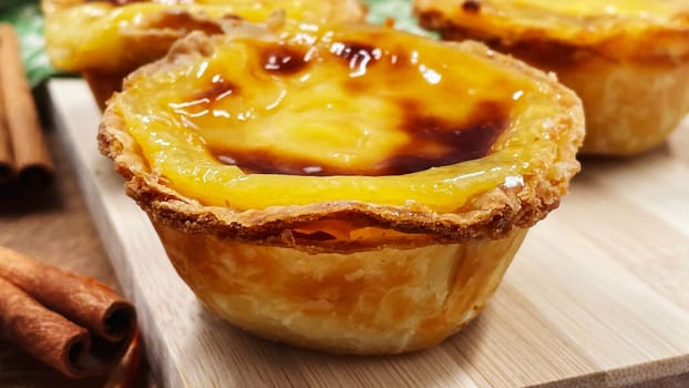 Lots of desserts Pastel de nata or Portuguese egg tart and cinnamon sticks. Pastel de Belm is a small pie with a crispy puff pastry crust and a custard cream filling