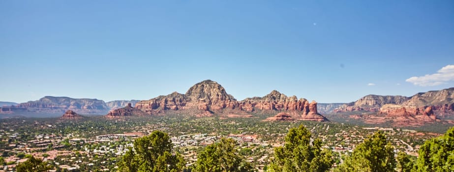 Sedona, Arizona in 2016: Panoramic view of vibrant town against majestic desert mountains and blue sky