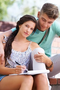 Students, couple and book with woman on stairs with smile, hug and portrait with notes at university. People, studying and scholarship for knowledge, education and notebook with embrace at college.